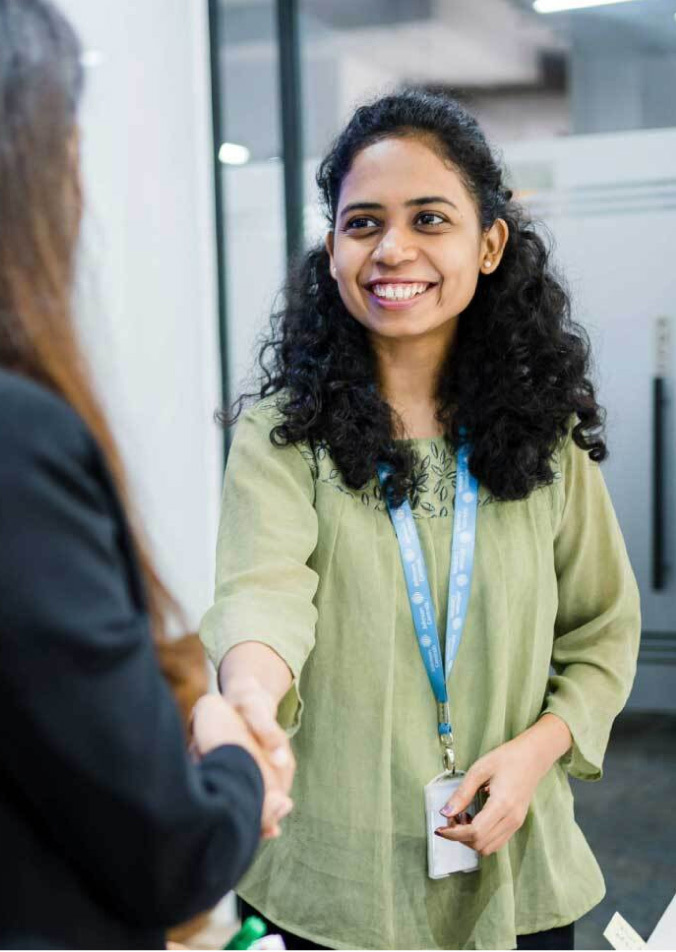 Two women shaking hands
