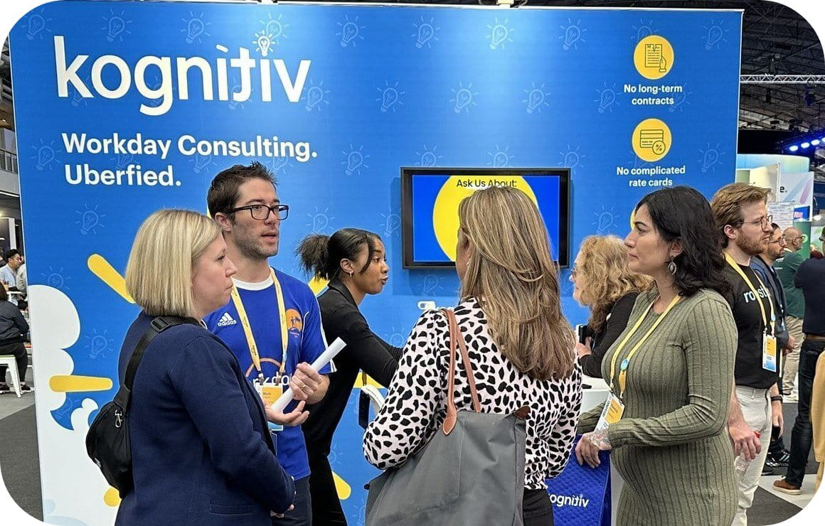 People networking at a Kognitiv booth during a professional event.