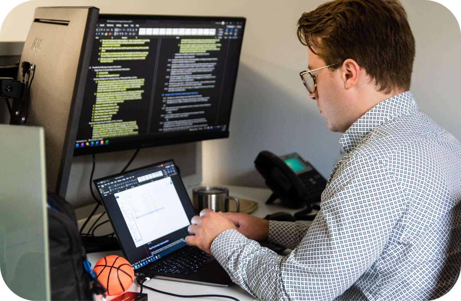Person working at a desk with a laptop